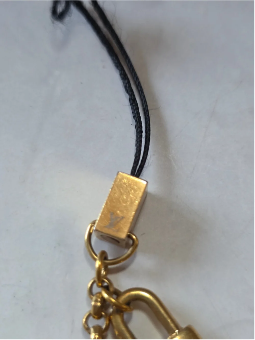 Louis Vuitton Gold-Tone Monogram Lock & Charm Phone Strap